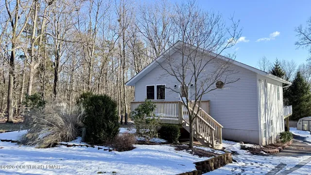 a view of a house with snow on the tree
