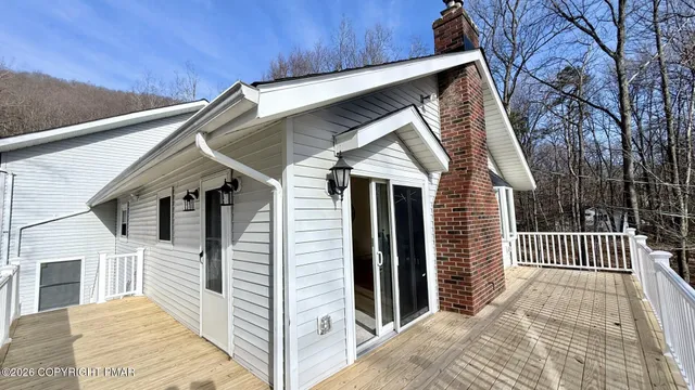 a view of a house with wooden fence
