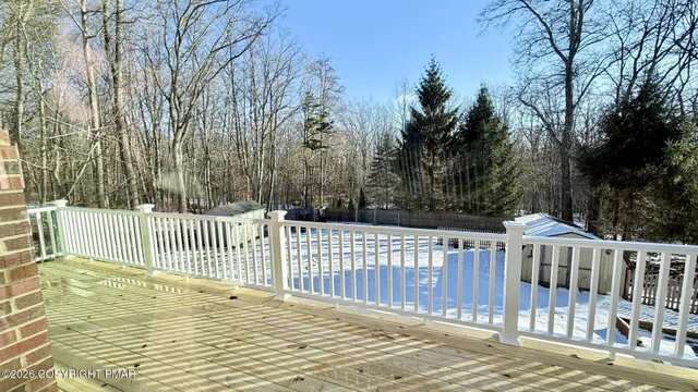 a view of a wooden deck and backyard