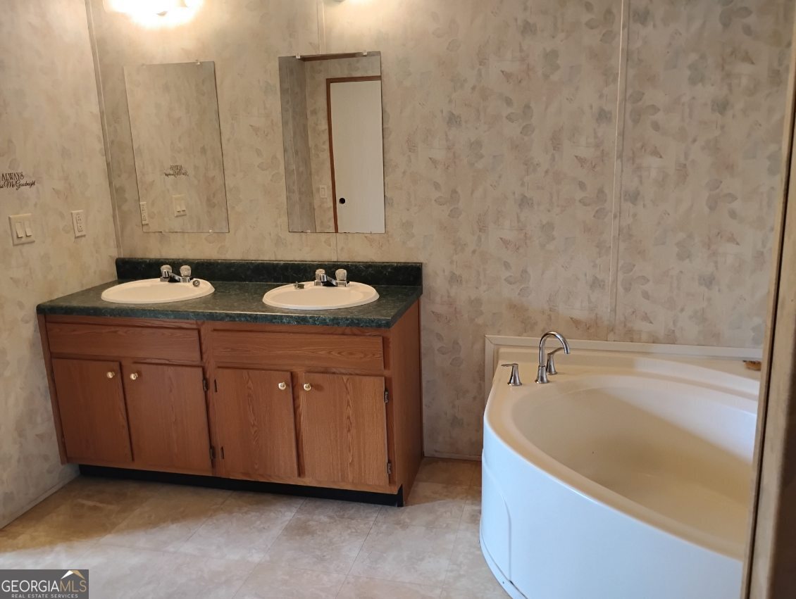 2331 Kesler Road Carnesville, GA 30521 - Photo 37 of 50 a bathroom with a tub sink and mirror