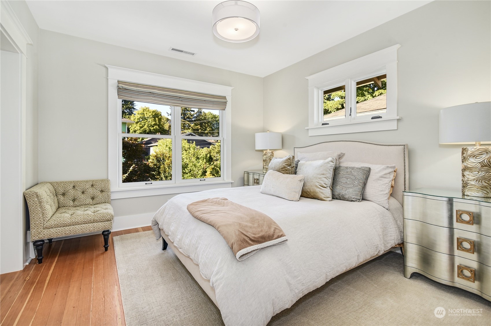 1249 18th Avenue East Seattle, WA 98112 - Photo 18 of 39 a bedroom with a large bed couch and a large window