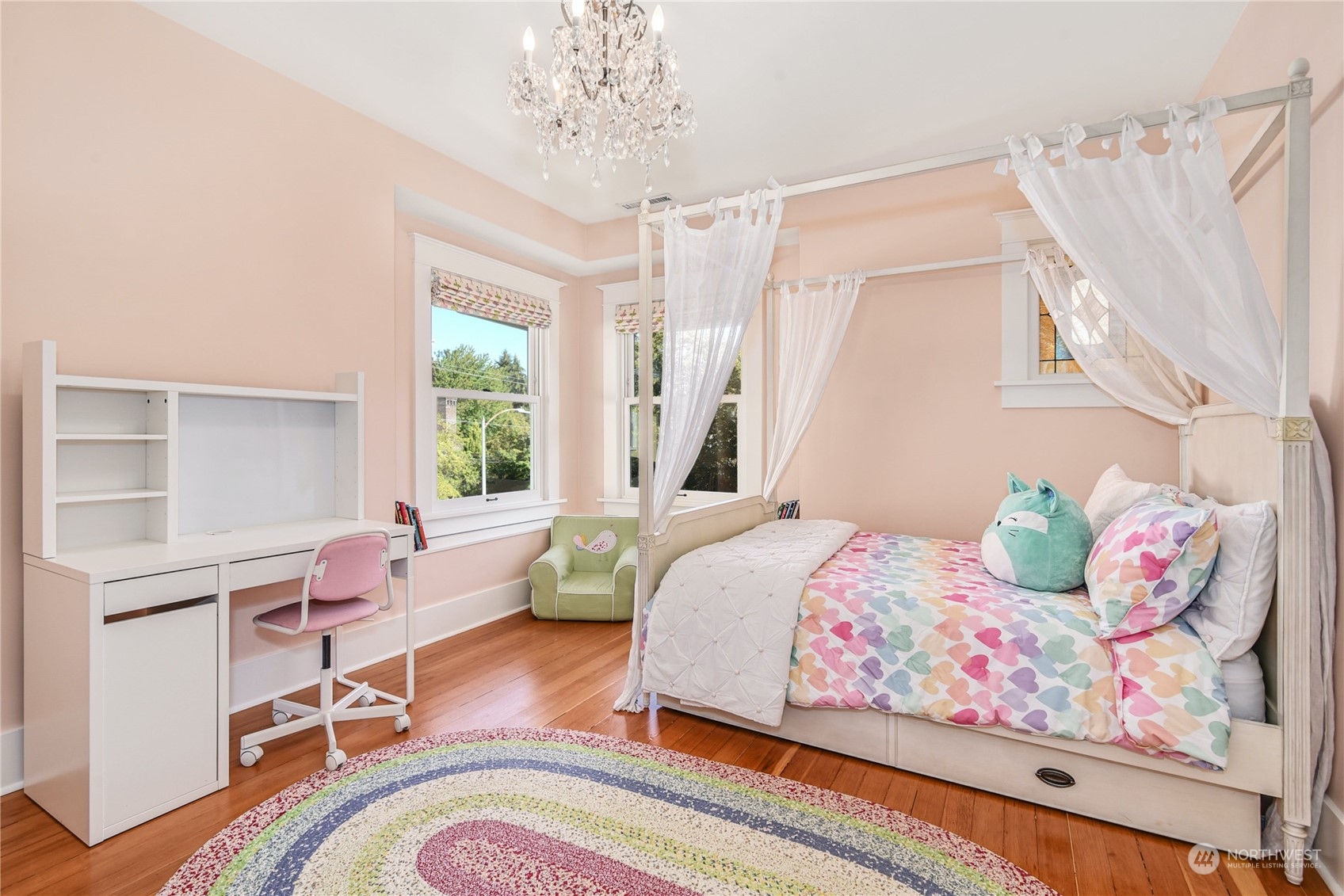 1249 18th Avenue East Seattle, WA 98112 - Photo 23 of 39 a bedroom with a bed and a chandelier