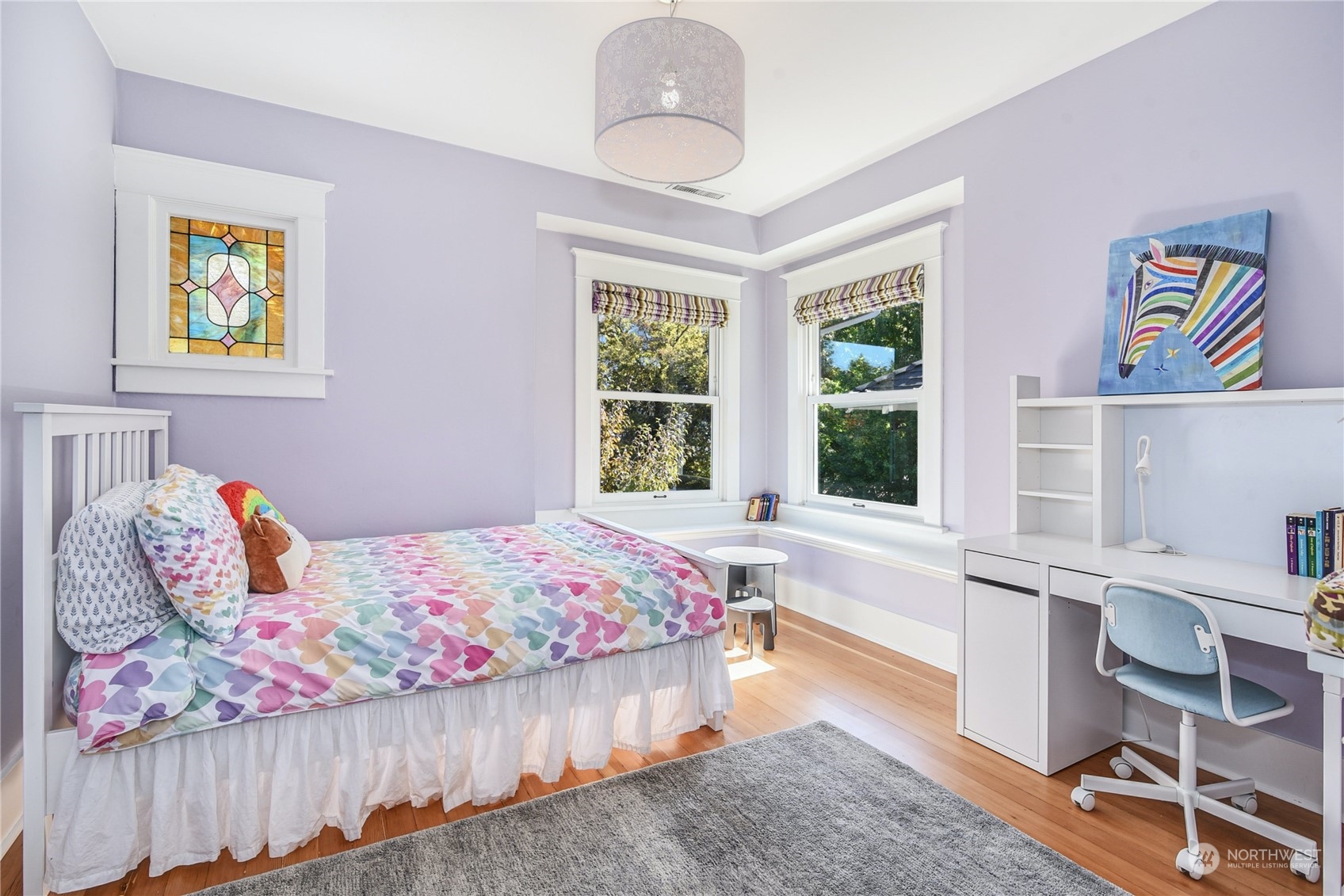 1249 18th Avenue East Seattle, WA 98112 - Photo 25 of 39 a bedroom with a bed and a chandelier