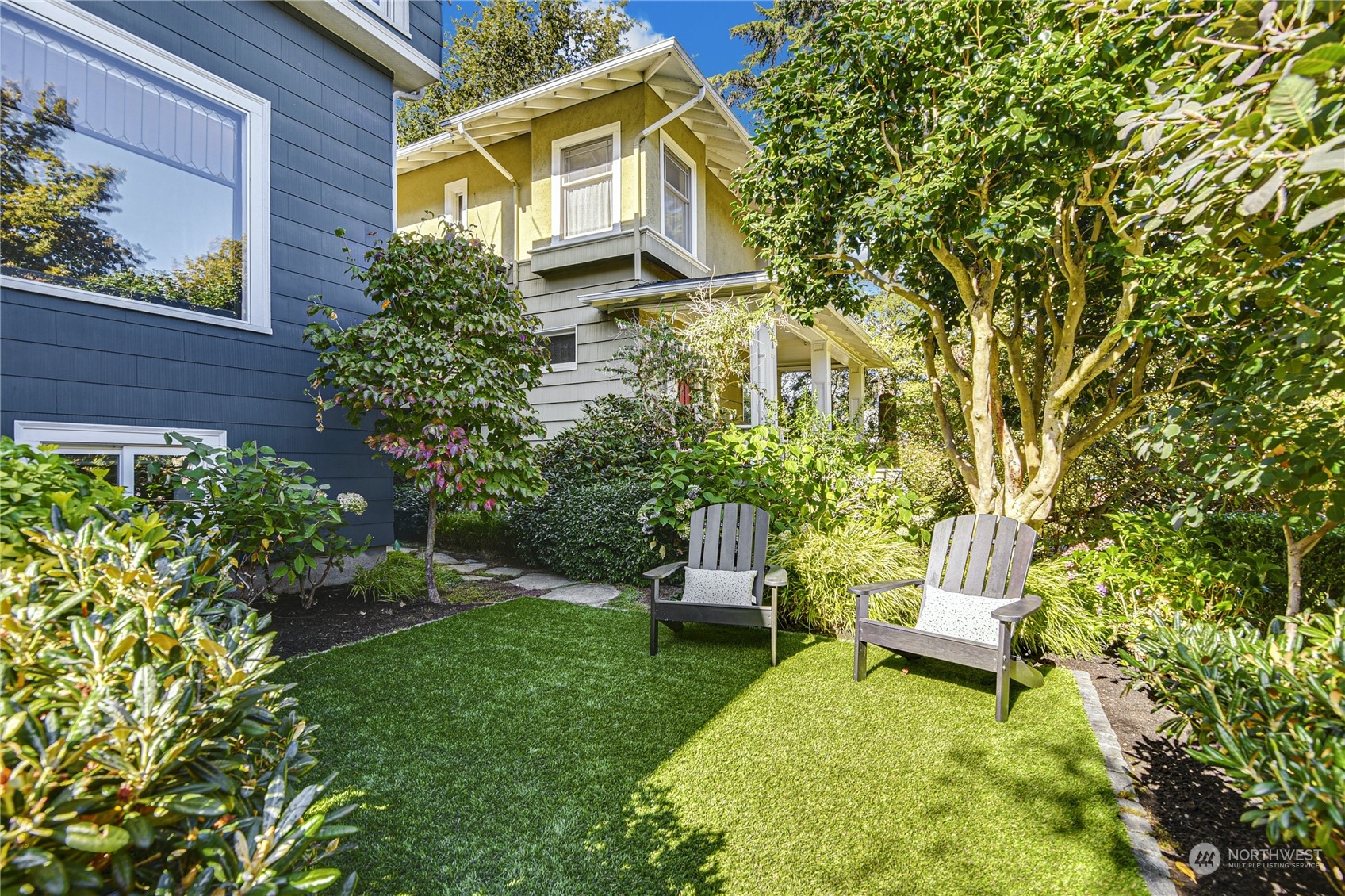 1249 18th Avenue East Seattle, WA 98112 - Photo 34 of 39 a view of a backyard with table and chairs and potted plants