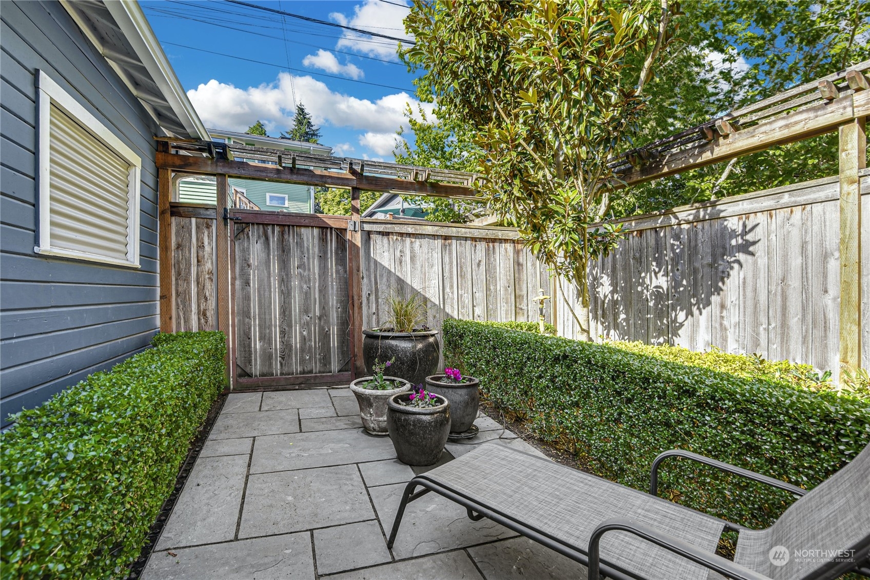 1249 18th Avenue East Seattle, WA 98112 - Photo 36 of 39 a backyard of a house with table and chairs