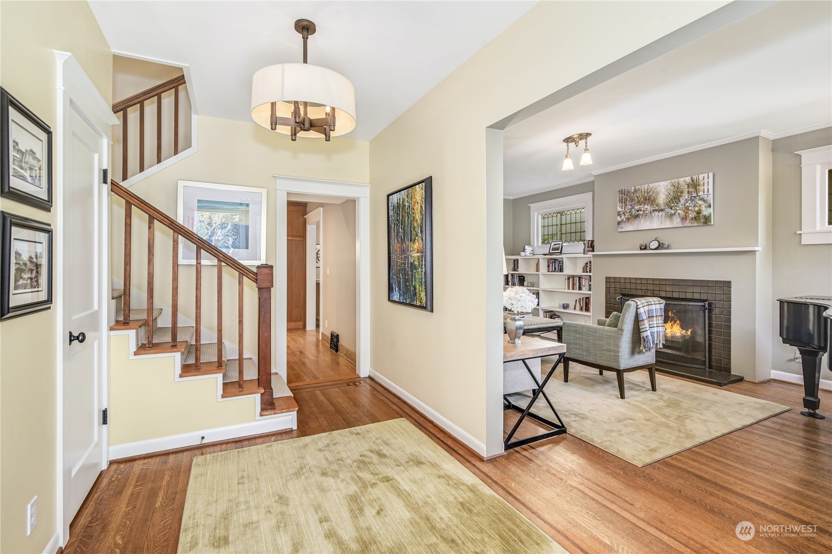 1249 18th Avenue East Seattle, WA 98112 - Photo 6 of 39 a view of a livingroom with furniture a fireplace wooden floor and staircase