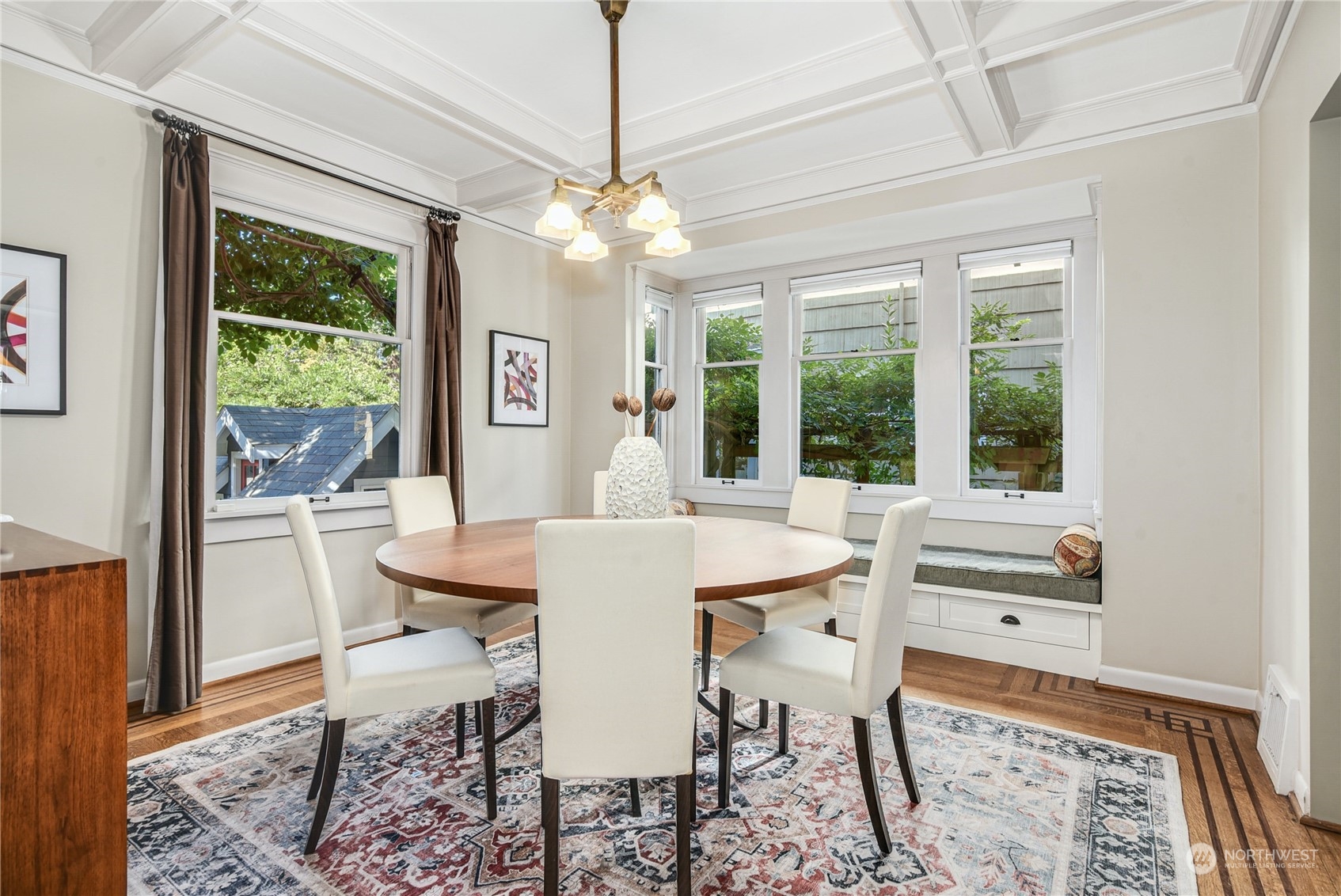 1249 18th Avenue East Seattle, WA 98112 - Photo 10 of 39 a dining room with wooden floor a chandelier a wooden table and chairs