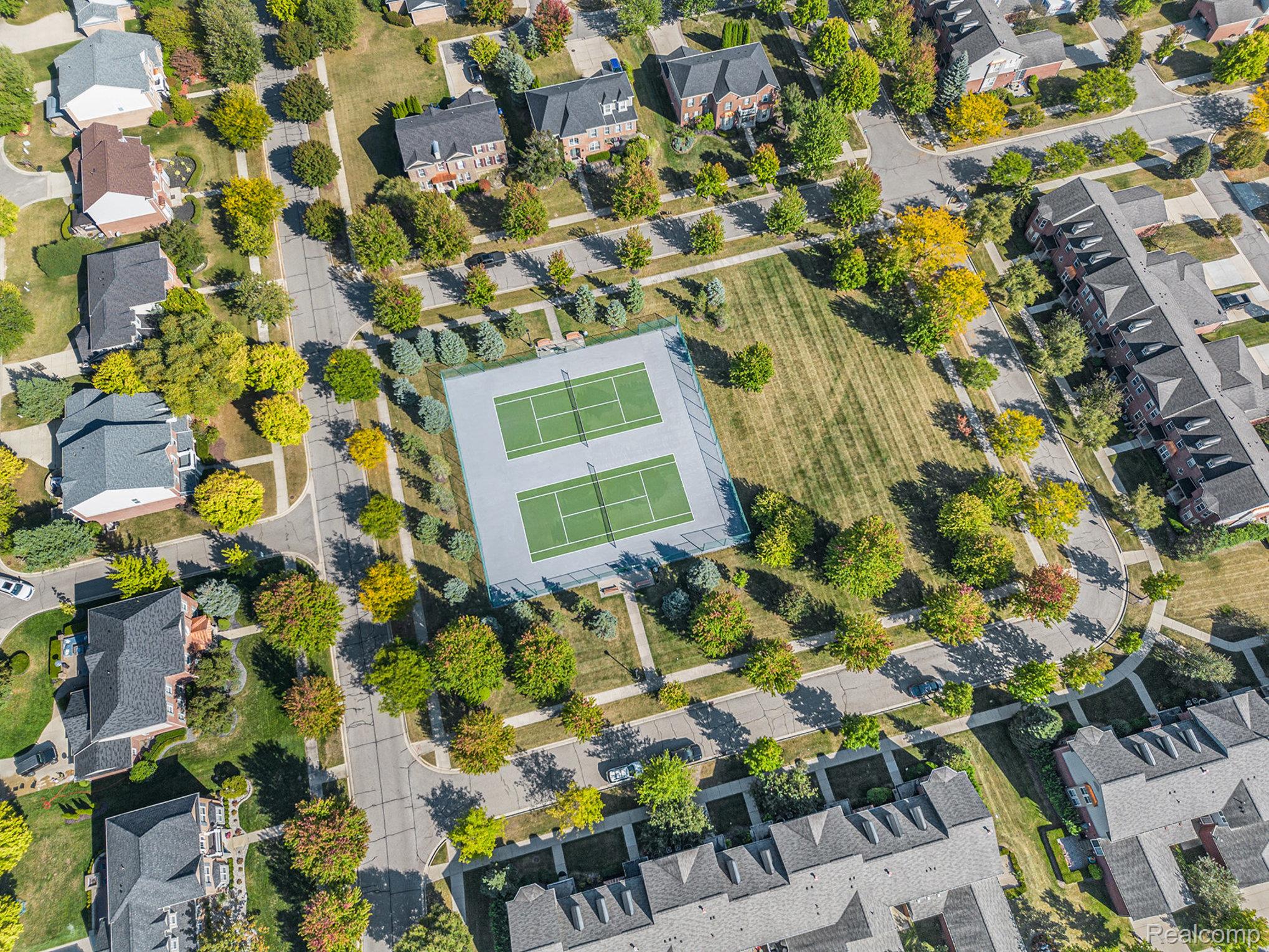 50873 Scarborough Road Canton, MI 48188 - Photo 32 of 33 Community green space featuring dual tennis courts and expansive lawn areas