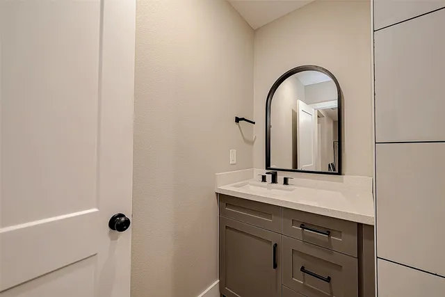 a bathroom with a sink and a mirror