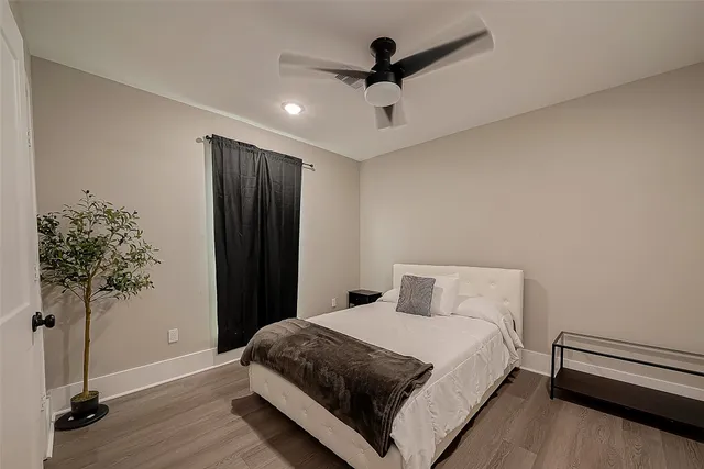 a bedroom with a bed and a potted plant