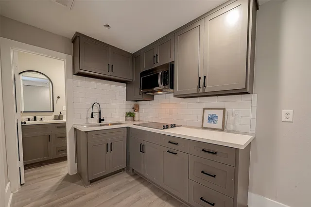 a kitchen with a sink cabinets and stainless steel appliances