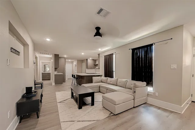 a living room with furniture and a lamp