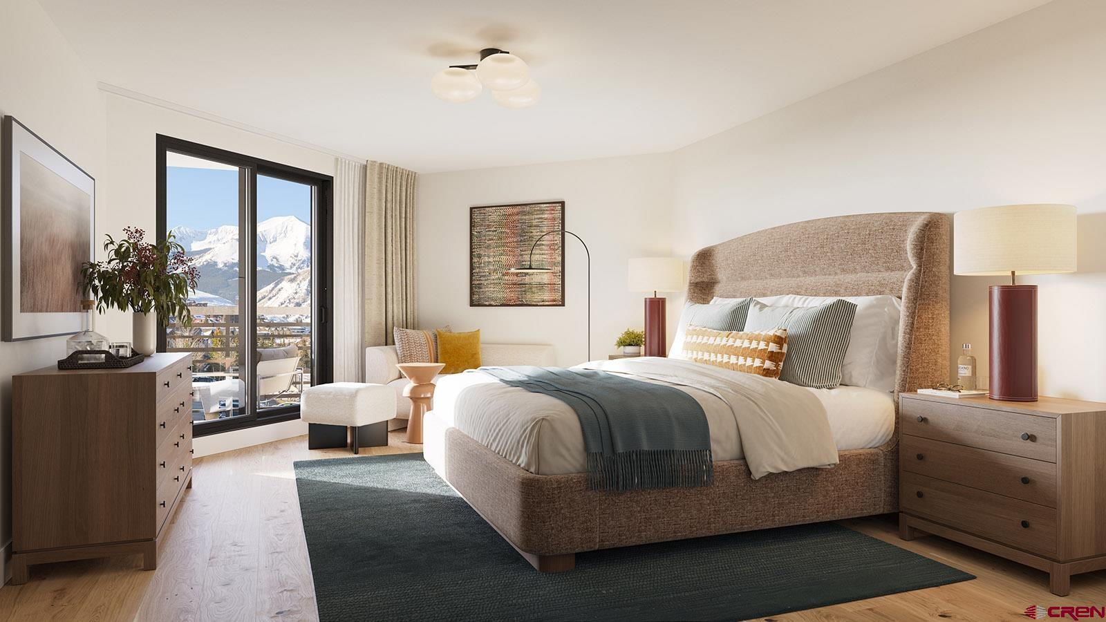 500 Gothic Road, Unit 339 Crested Butte, CO 81225 - Photo 5 of 17 a bedroom with a large bed and a couch