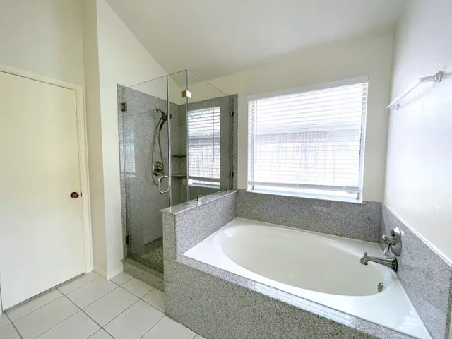 a bathroom with a bathtub and a shower