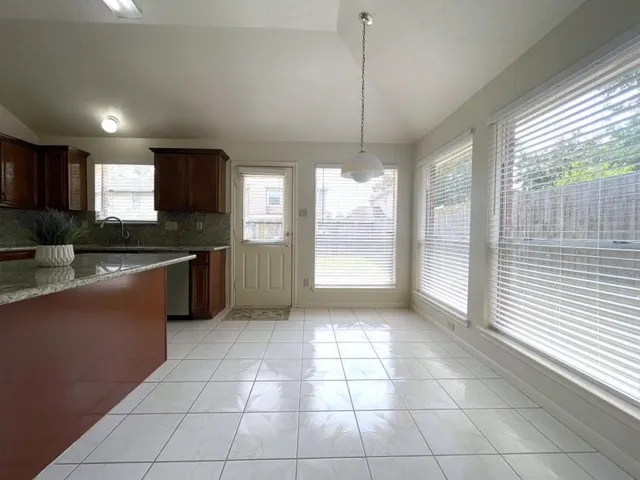 a kitchen with stainless steel appliances granite countertop a stove a sink a counter space and cabinets