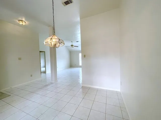a view of a hallway with a chandelier