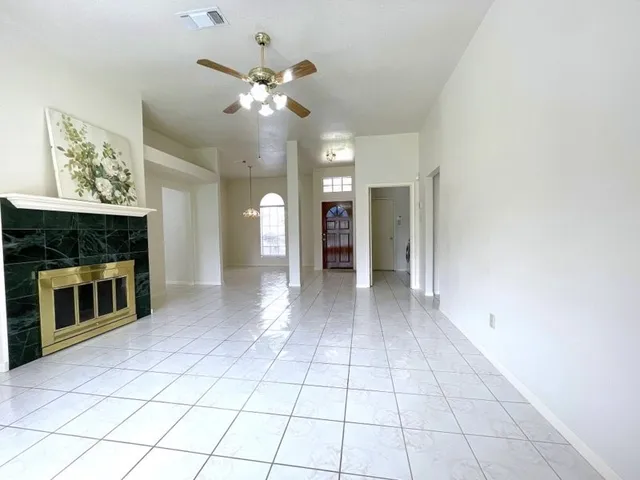 a view of an empty room with a fireplace