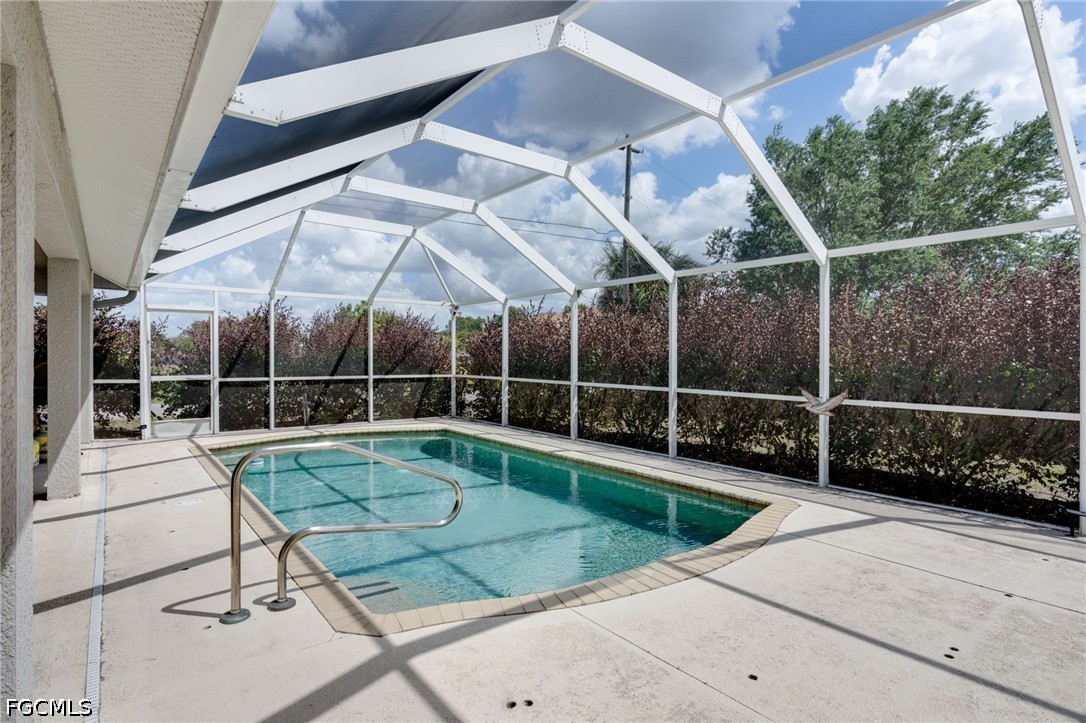 3801 28th Street Southwest Lehigh Acres, FL 33976 - Photo 23 of 37 a view of a swimming pool with a yard and furniture