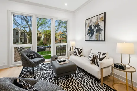 a living room with furniture and a floor to ceiling window