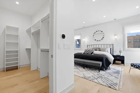a bedroom with a bed and a view of closet