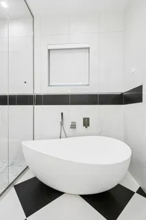 a bathroom with a bathtub and a shower