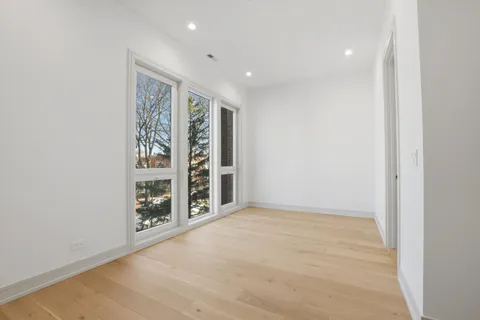 an empty room with windows and closet