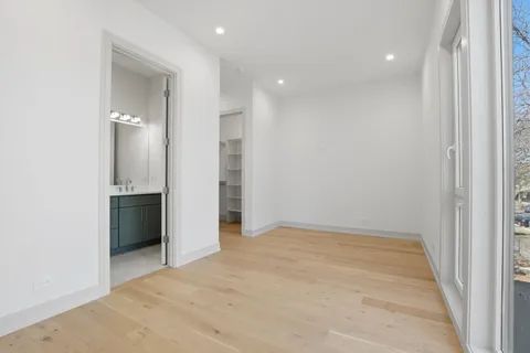 an empty room with closet and a bathroom