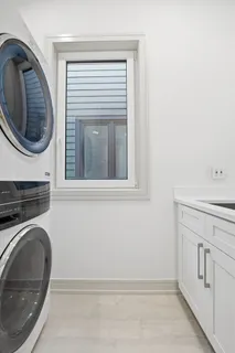a utility room with sink dryer and washer