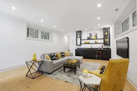 a living room with furniture and kitchen view