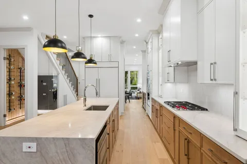 a kitchen with stainless steel appliances kitchen island a refrigerator and a stove top oven