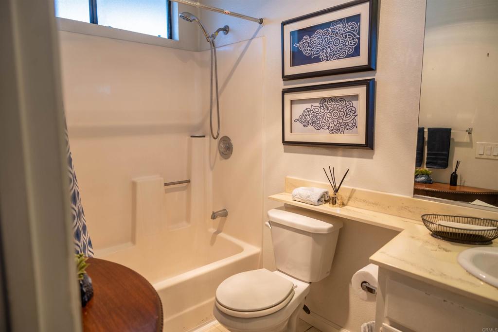 2910 Elm Tree Court Spring Valley, CA 91978 - Photo 13 of 27 a bathroom with a granite countertop toilet sink and mirror