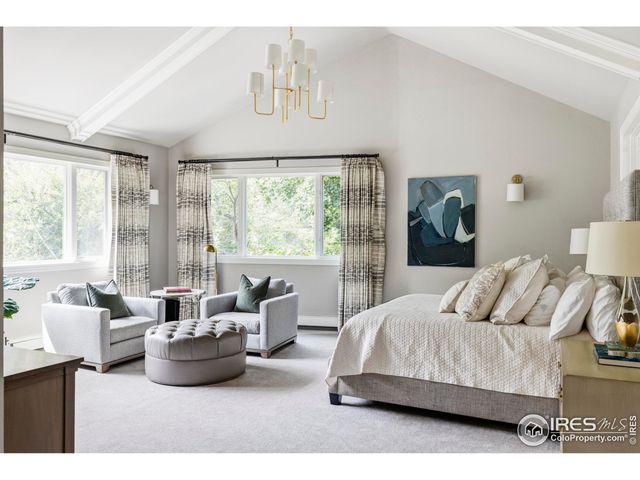 a bedroom with furniture and large windows