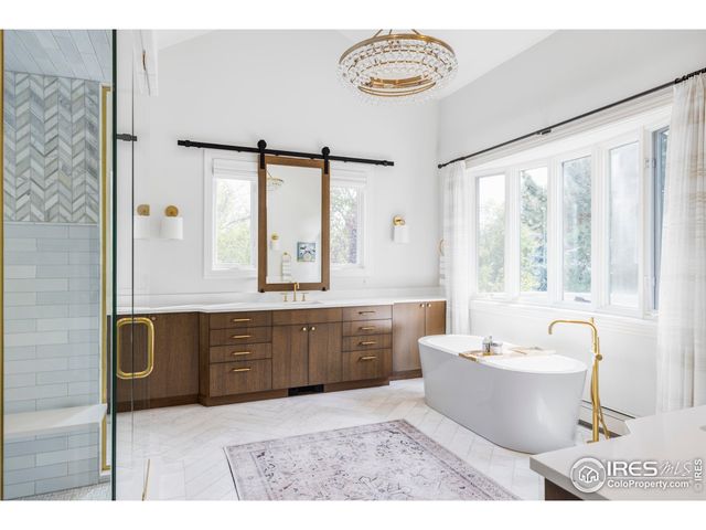 a spacious bathroom with a bathtub sink and mirror