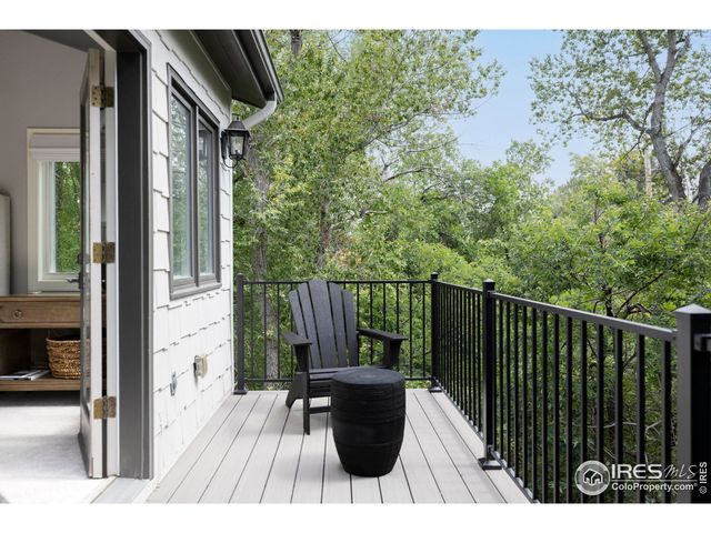 a view of balcony with wooden floor and outdoor seating
