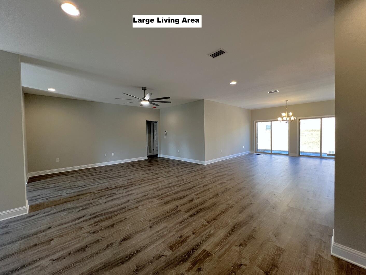 445 Scooter Cove Crestview, FL 32539 - Photo 6 of 22 a view of empty room with wooden floor