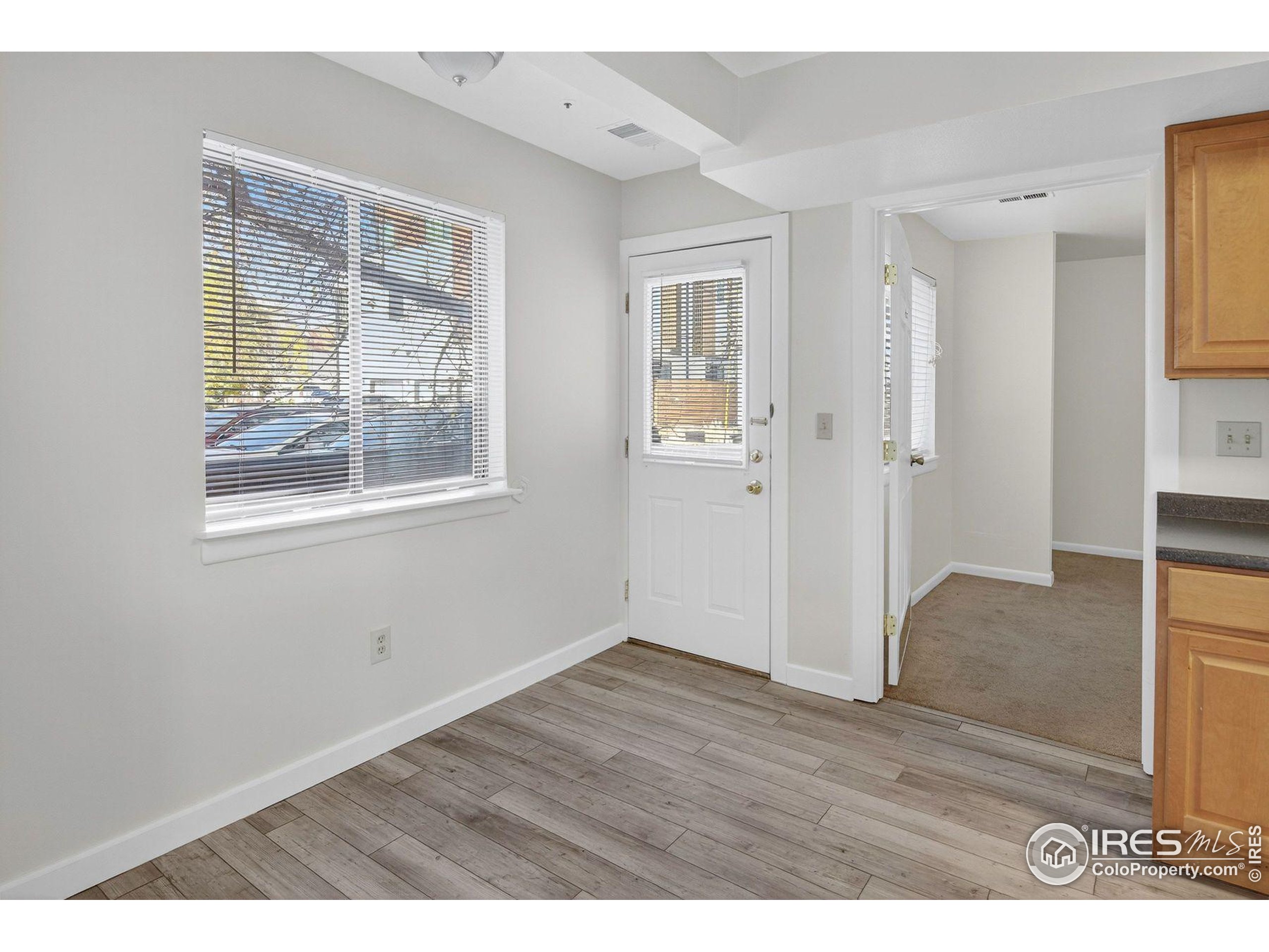 2317 Walnut Street Boulder, CO 80302 - Photo 11 of 34 a view of an empty room with wooden floor and a window