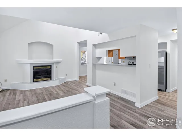 a living room with a fireplace furniture and a wooden floor