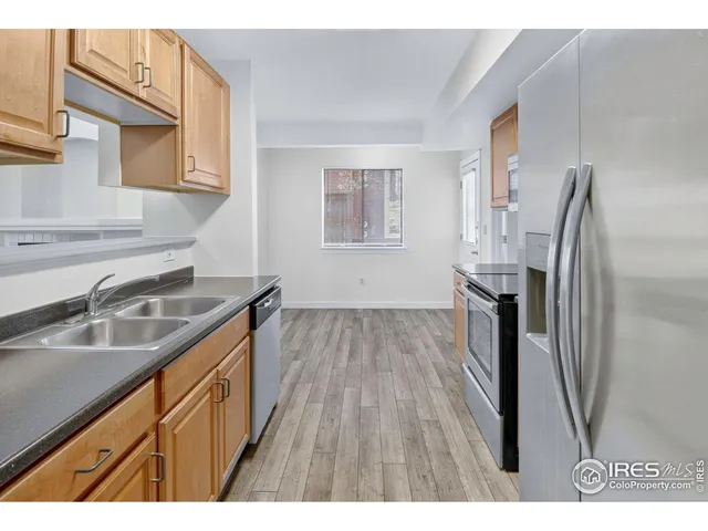 a kitchen with stainless steel appliances granite countertop a stove and a refrigerator