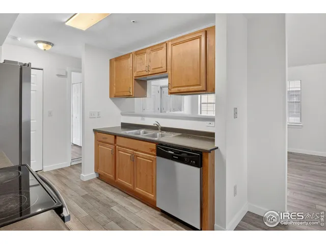 a kitchen with stainless steel appliances a stove a microwave a sink and cabinets