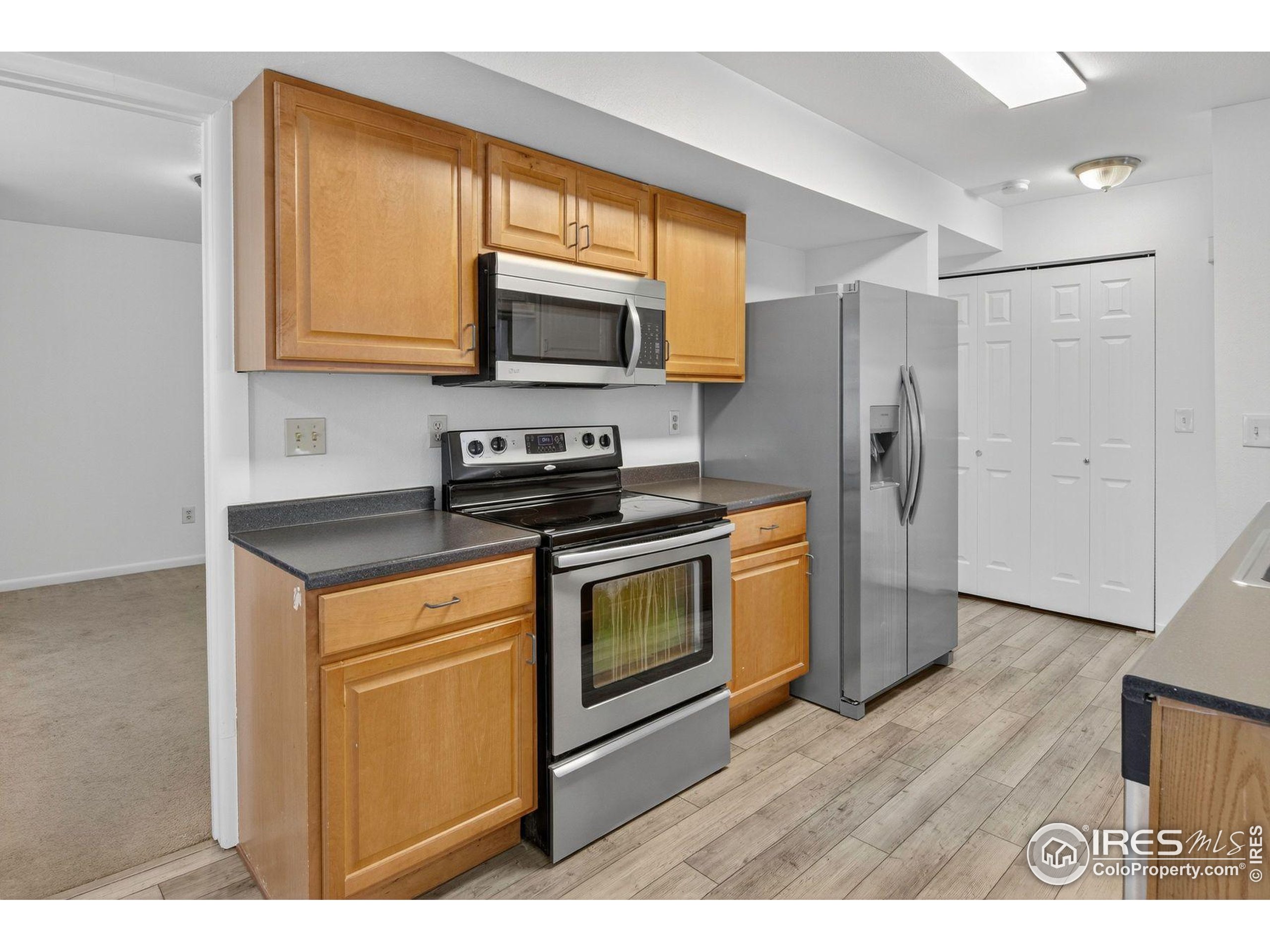 2317 Walnut Street Boulder, CO 80302 - Photo 10 of 34 a kitchen with stainless steel appliances a stove a microwave a sink and cabinets