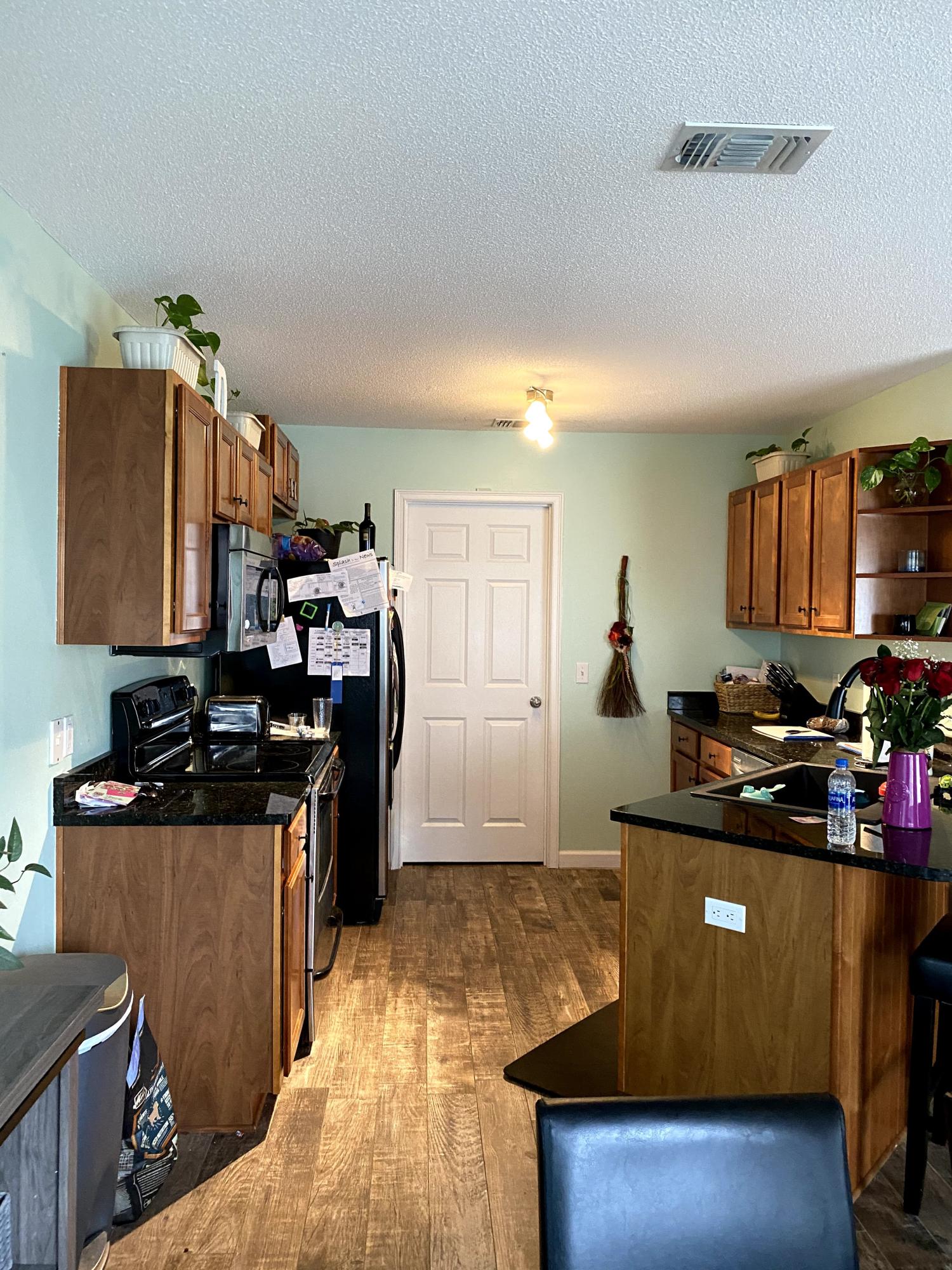 26 3rd Street Shalimar, FL 32579 - Photo 14 of 21 a kitchen with kitchen island granite countertop a sink counter top space appliances and cabinets