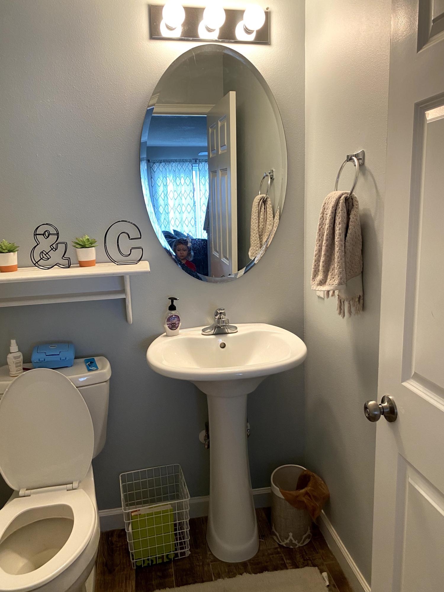 26 3rd Street Shalimar, FL 32579 - Photo 16 of 21 a bathroom with a toilet sink and mirror