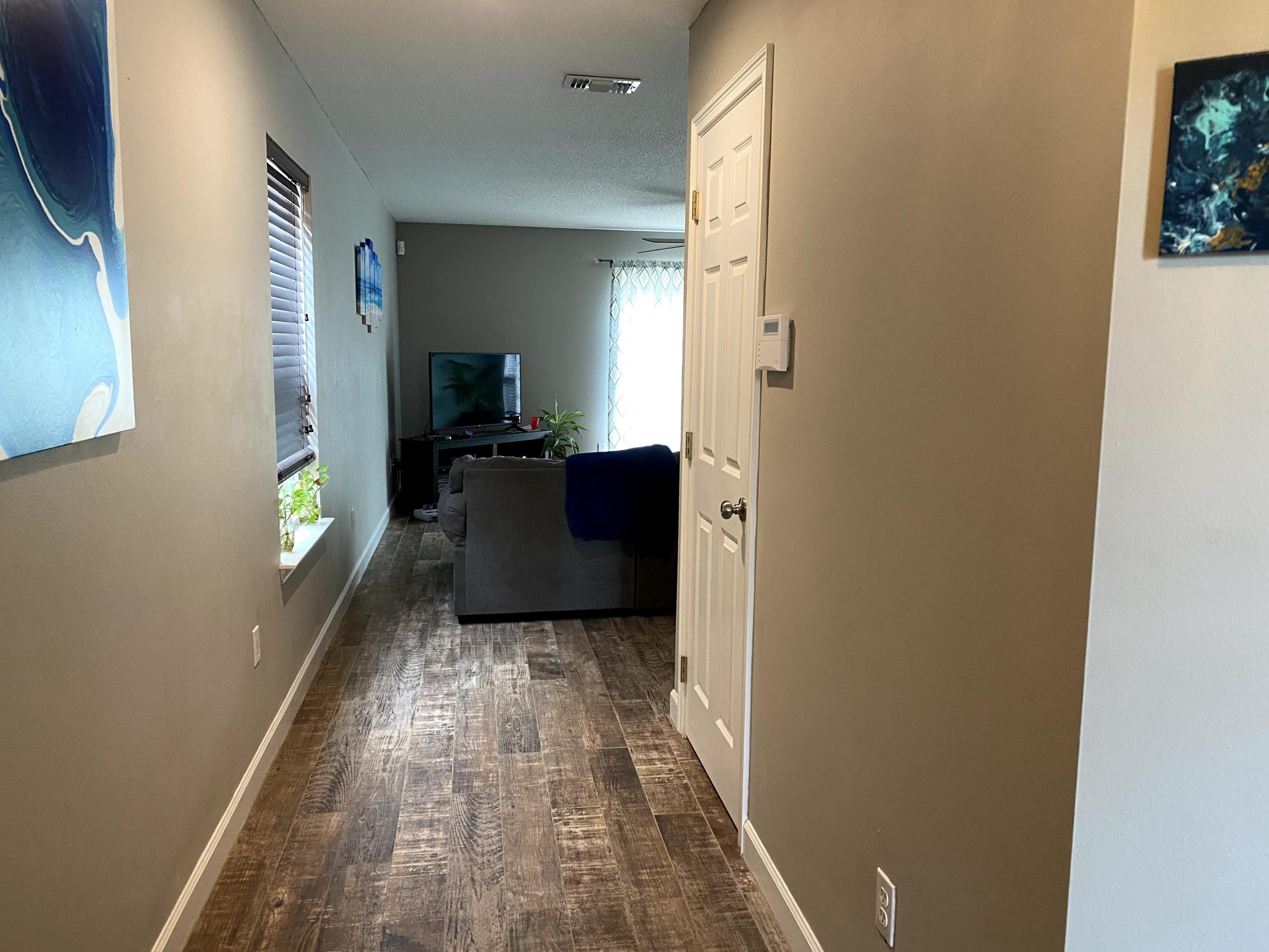 26 3rd Street Shalimar, FL 32579 - Photo 21 of 21 a view of a hallway with wooden floor and furniture