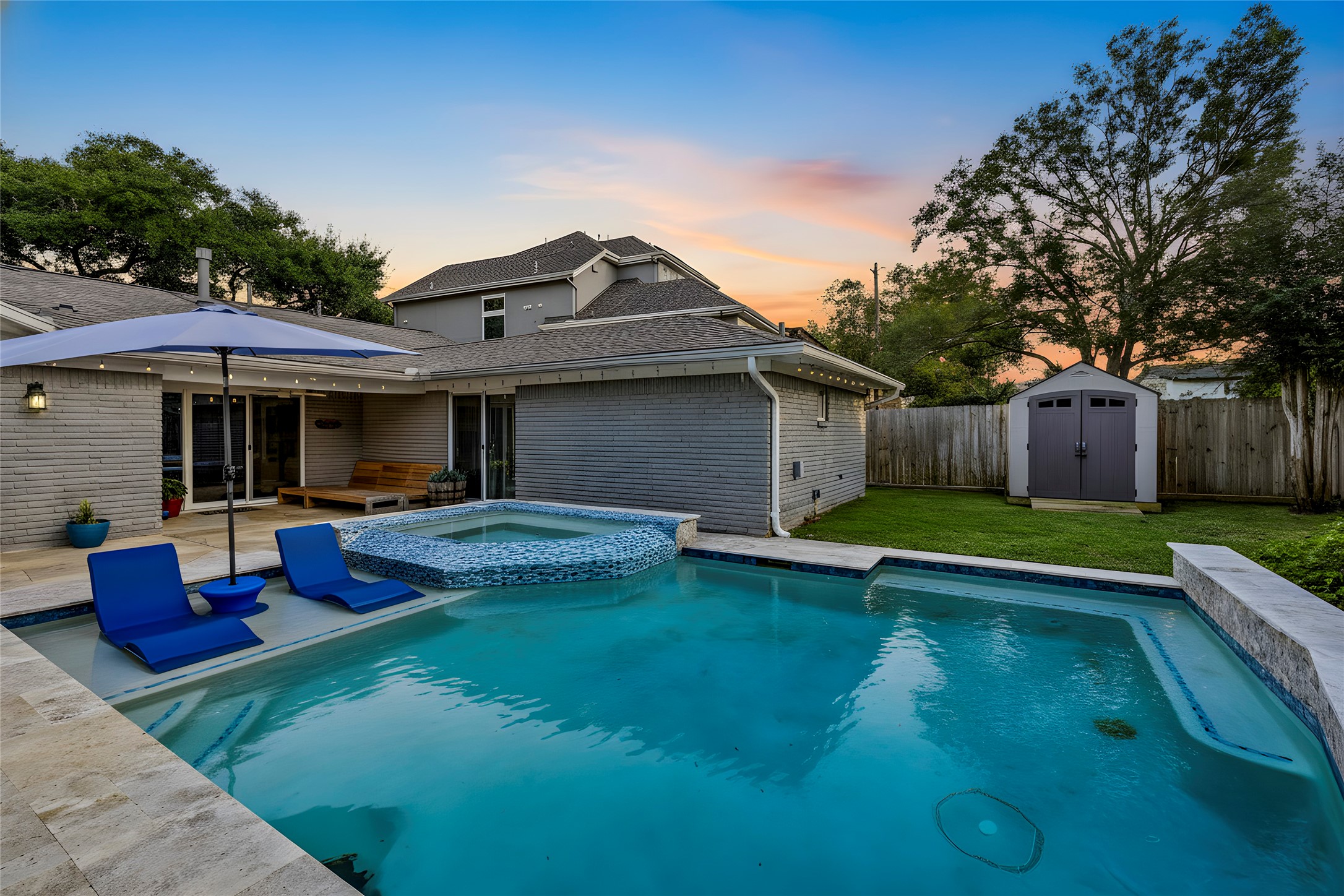 a view of a house with a yard and sitting area