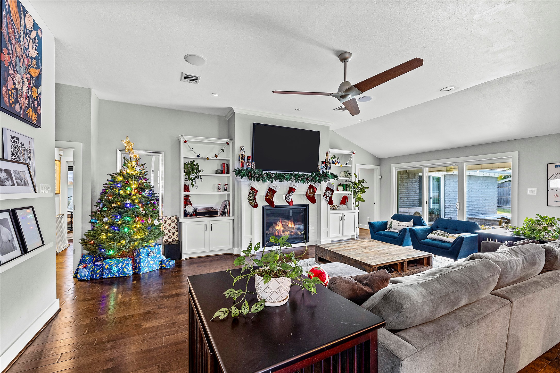 8422 Academy Street Houston, TX 77025 - Photo 11 of 47 a living room with furniture a flat screen tv and a dining table