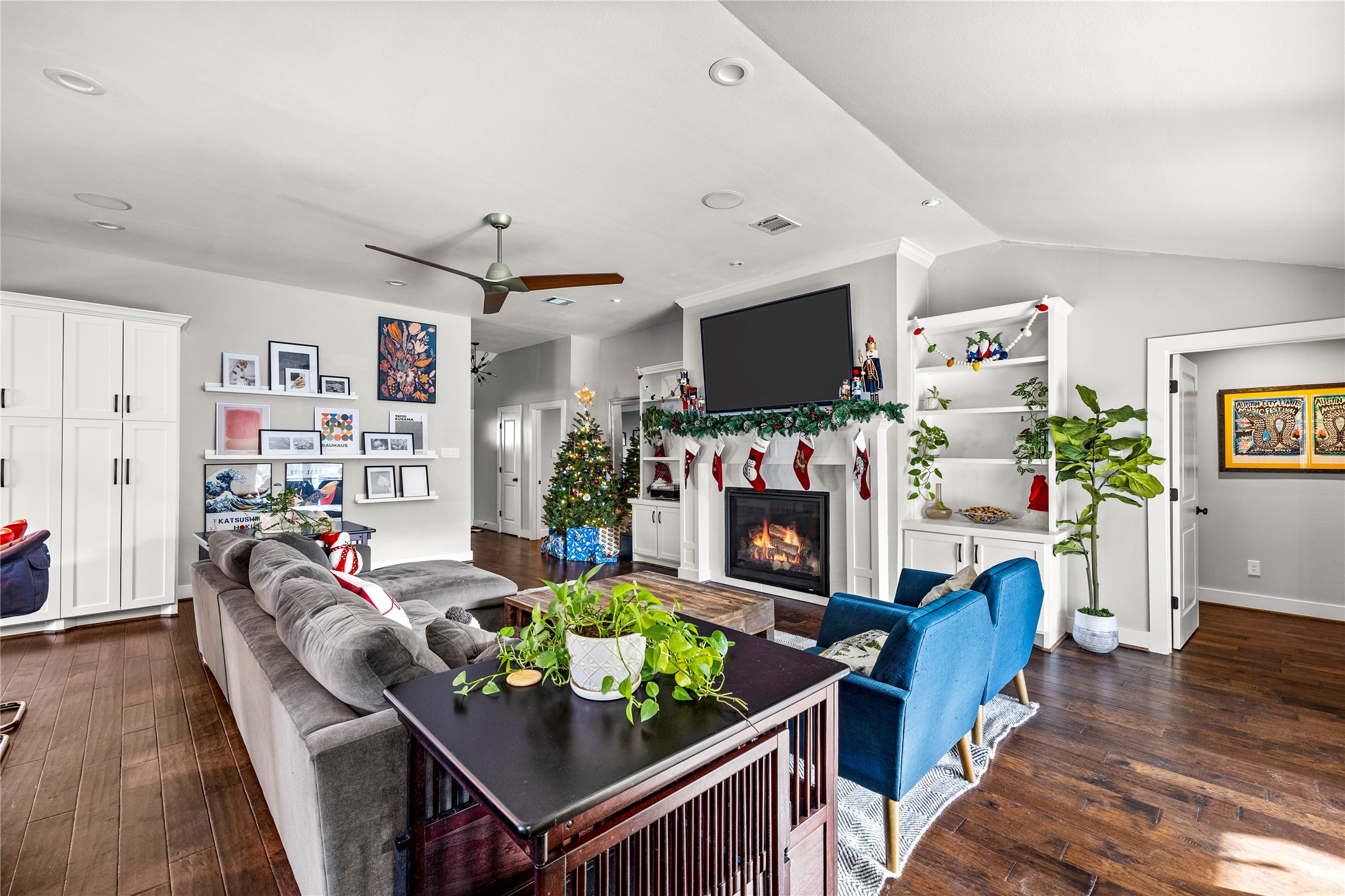 8422 Academy Street Houston, TX 77025 - Photo 12 of 47 a living room with furniture a flat screen tv and a dining table