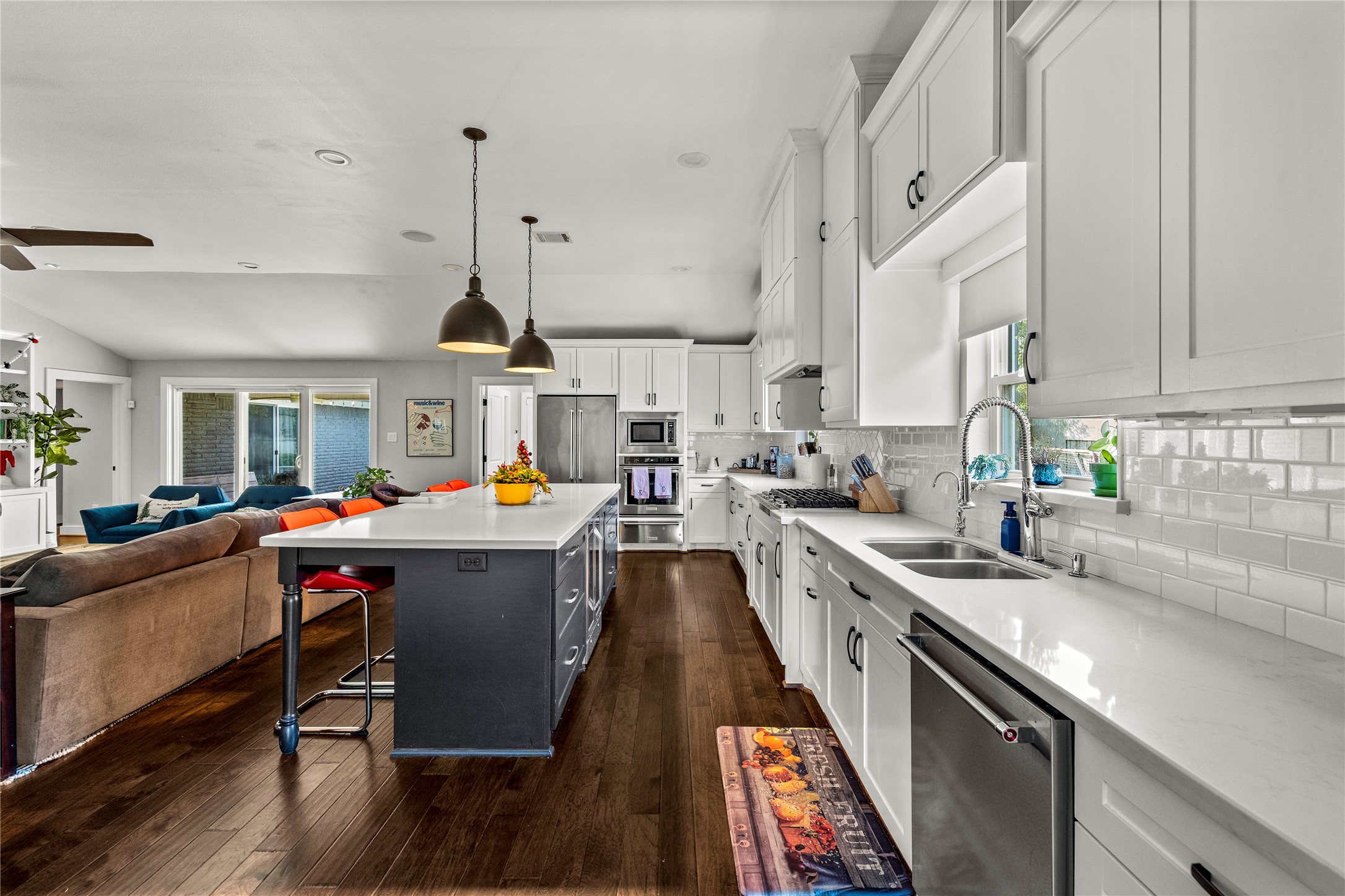 8422 Academy Street Houston, TX 77025 - Photo 15 of 47 a kitchen with stainless steel appliances granite countertop a sink a stove and a wooden floors