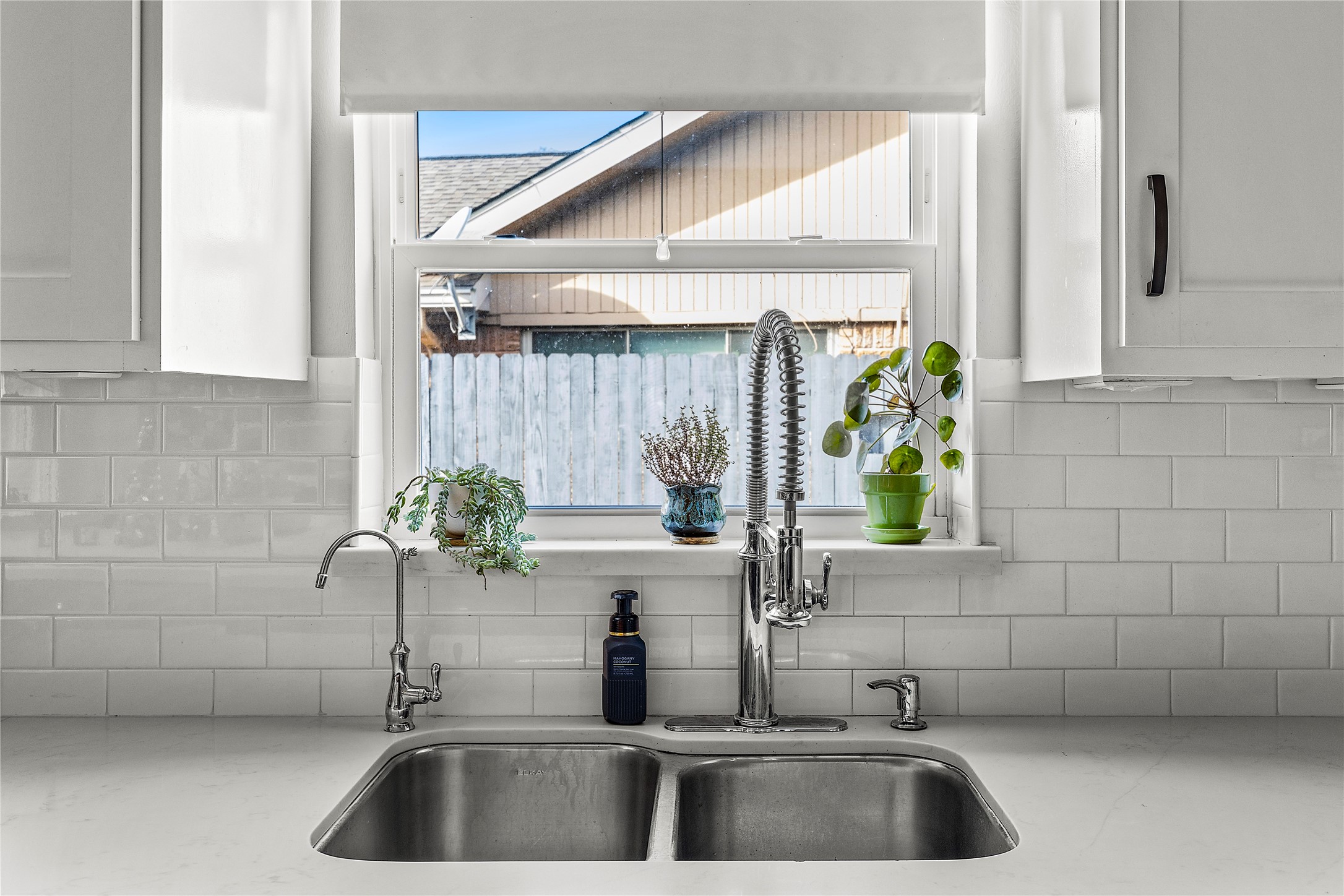 8422 Academy Street Houston, TX 77025 - Photo 17 of 47 a bathroom with a sink a potted plant and a window