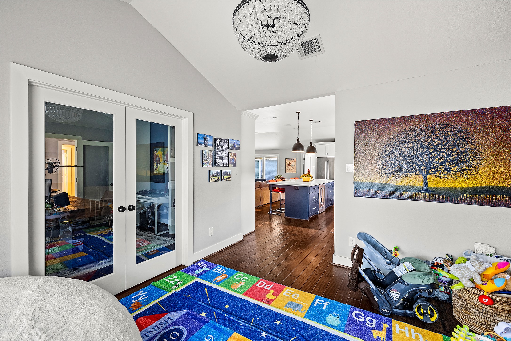 8422 Academy Street Houston, TX 77025 - Photo 19 of 47 A bright and flexible dining space featuring elegant French doors and vaulted ceilings. This room opens seamlessly to the kitchen and living area, offering great flow for entertaining or use as a playroom, study, or additional living space.