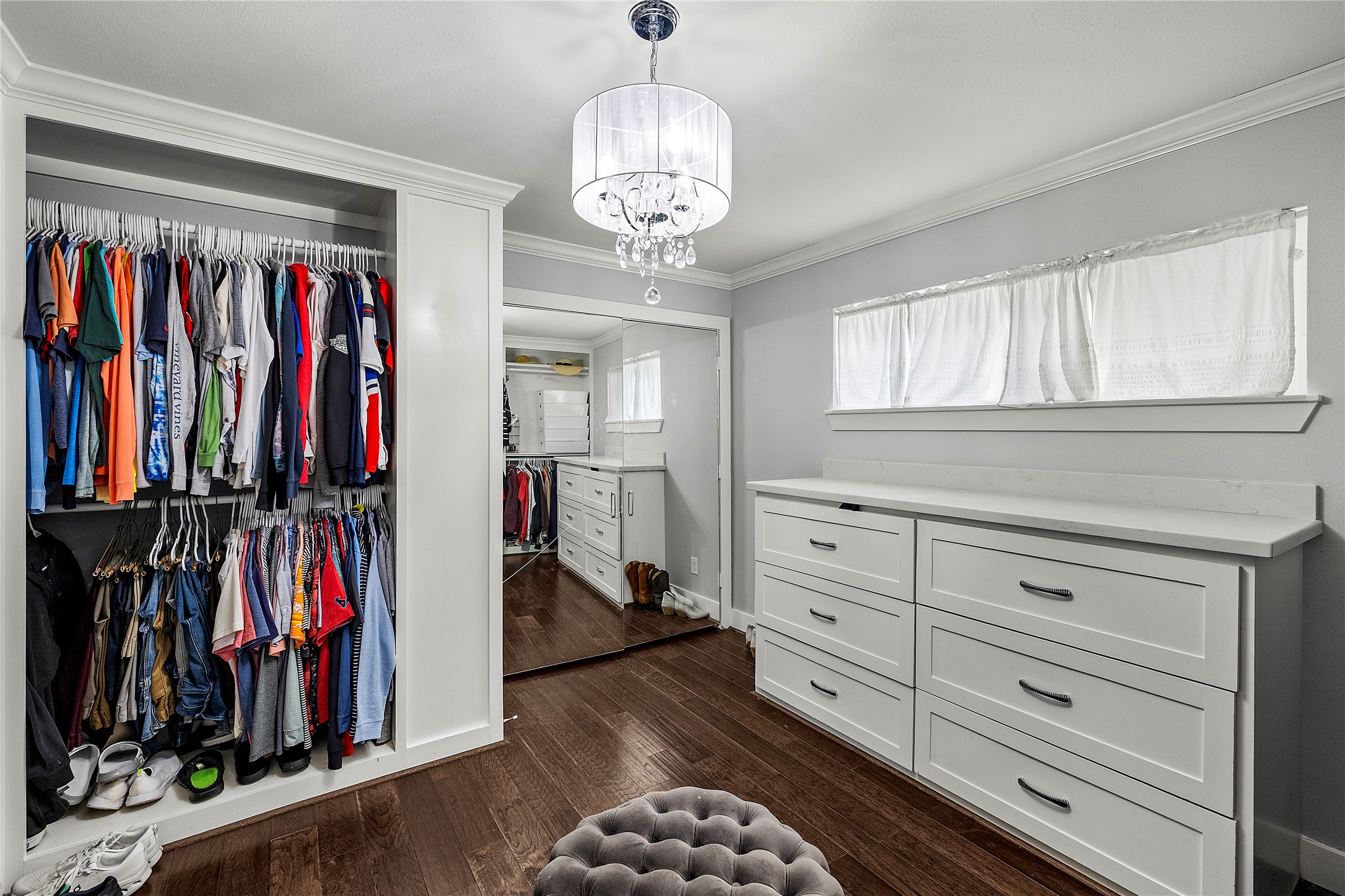 8422 Academy Street Houston, TX 77025 - Photo 23 of 47 a view of walk in closet with clothes and shoes